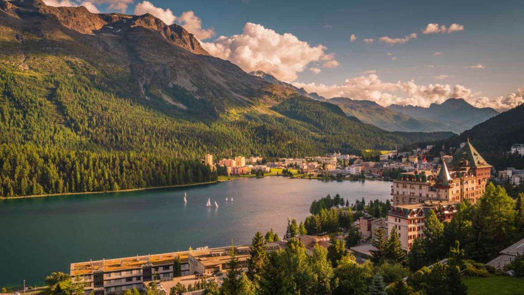 Scenic view of St. Moritz with mountains and lake, perfect for summer trips.